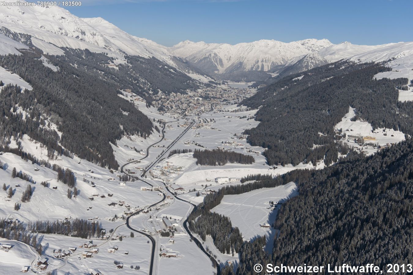 im hintern Bildteil: Davos-Platz und Davos-Dorf mit Davoser-See (Blickrichtung NNE). Ganz vorne im Bild: Davos-Frauenkirch. Waldlichtung rechts: 'Gämpa'